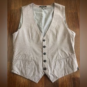 Elevate your outfit with this beige, blue. and red vest.